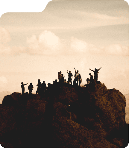 Silhouettes of people on a hilltop at sunset